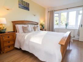 A bedroom with a bed and nightstand at Castle View Lodge Ilfracombe