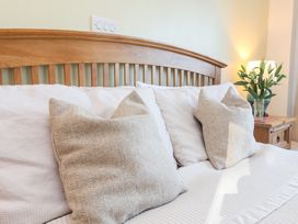 A bedroom with a bed and pillows at Castle View Lodge in Ilfracombe