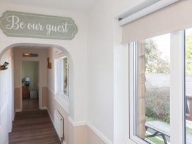 A hallway with a window and a sign at Castle View Lodge Ilfracombe