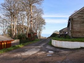 An outdoor view with cabins and trees at Castle View Lodge Ilfracombe