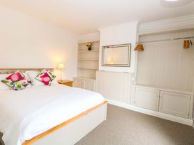 A bedroom with a bed and shelf at Highland House in Sheringham