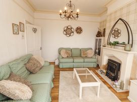 A living room with a coffee table and sofa at 2 The Crescent