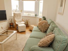 A living room with a sofa, coffee table, and television at 2 The Crescent