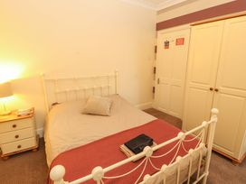 A bedroom with a bed and wardrobe at 2 The Crescent