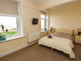 A bedroom with a bed and television at 2 The Crescent
