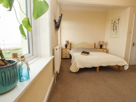 A bedroom with a bed and nightstands at 2 The Crescent