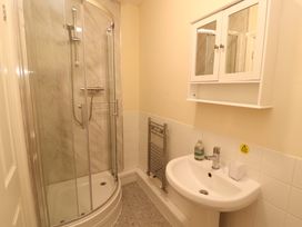 A bathroom with a shower, sink, and mirror cabinet at 2 The Crescent