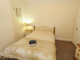 A bedroom with a bed and lamp at 2 The Crescent 
