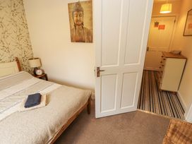 A bedroom with a bed and a door leading to another room at 2 The Crescent
