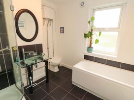 A bathroom with a sink, toilet, bathtub and shower at 2 The Crescent