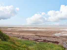 A view of the sea and sand with clouds at 2 The Crescent 