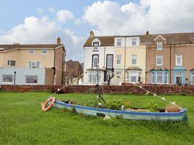 A boat in a garden with houses in the background at 2 The Crescent