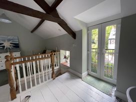 A landing area with a railing and stairs at Riverwash Cottage in Dwygyfylchi