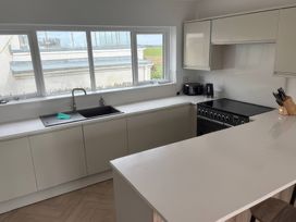 A kitchen with a sink and stove at Seaddler in Trearddur Bay