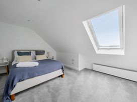 A bedroom with a bed and window at Seaddler in Trearddur Bay