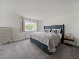 A bedroom with a bed and dresser at Seaddler in Trearddur Bay