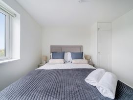 A bedroom with a bed and pillows at Seaddler in Trearddur Bay