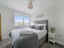 A bedroom with a bed and nightstand at Seaddler in Trearddur Bay