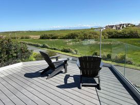 An outdoor area with chairs and a view at Seaddler in Trearddur Bay
