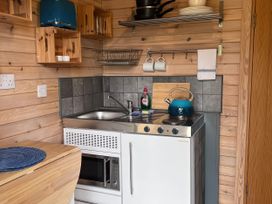A kitchen with a sink and stove at Lakeside Pods - pet free Greenfield