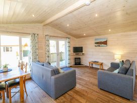 A living room with sofas and a dining table at Dovestone Luxury Lodges (sleeps 4)- pet free, Greenfield