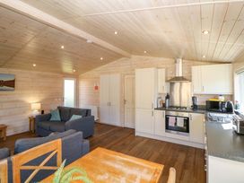 A kitchen with sofa and dining area at Dovestone Luxury Lodges (sleeps 4)- pet free in Greenfield