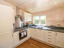 A kitchen with sink and stove at Dovestone Luxury Lodges (sleeps 4)- pet free, Greenfield