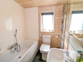 A bathroom with a shower and sink at Dovestone Luxury Lodges (sleeps 4)- pet free, Greenfield
