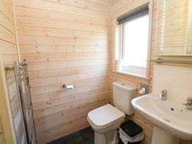 A bathroom with a toilet, sink, and towel rail at Dovestone Luxury Lodges (sleeps 4)- pet free, Greenfield