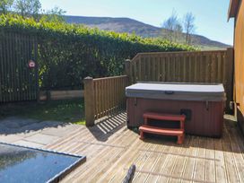 An outdoor area with a hot tub and decking at Dovestone Luxury Lodges (sleeps 4)- pet free, Greenfield