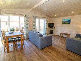 A living room with a dining table and sofa at Dovestone Luxury Lodges (sleeps 4) - pets welcome, Greenfield