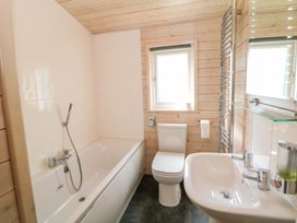 A bathroom with bathtub, toilet, and sink at Dovestone Luxury Lodges (sleeps 4) - pets welcome, Greenfield