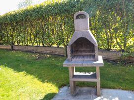 A barbecue grill in a garden at Dovestone Luxury Lodges (sleeps 4) - pets welcome, Greenfield