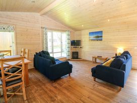 A living room with sofas and a dining table at Dovestone Luxury Lodges (sleeps 6) - pet free in Greenfield