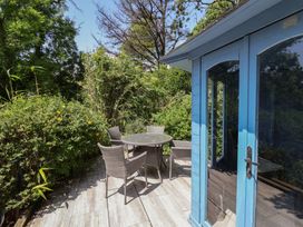 An outdoor seating area with a table and chairs at Upper Cottage in Rocombe near Uplyme