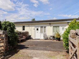 An outdoor area with a bench and plants at Stable Cottage Cottonshopeburnfoot near Otterburn