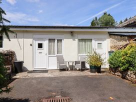 An outdoor area with a door and seating at Stable Cottage in Cottonshopeburnfoot near Otterburn