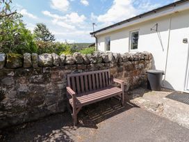 A bench near a stone wall at Stable Cottage Cottonshopeburnfoot near Otterburn