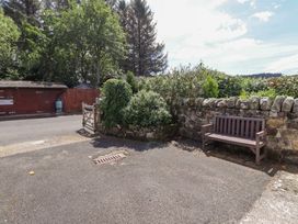 An outdoor area with a bench and a gate at Stable Cottage in Cottonshopeburnfoot near Otterburn