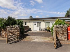 An exterior view of a cottage with a gate and plants at Stable Cottage Cottonshopeburnfoot near Otterburn
