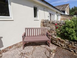 A bench in front of a house at Fir Tree Cottage Cottonshopeburnfoot near Otterburn