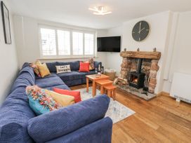 A living room with a sofa and fireplace at Daisy Cottage in Wigton
