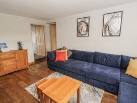 A living room with a sofa and coffee table at Daisy Cottage in Wigton