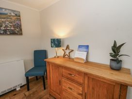 A corner with a chair and a drawer unit at Daisy Cottage in Wigton