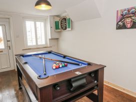 A snug with a pool table and dartboard at Daisy Cottage in Wigton