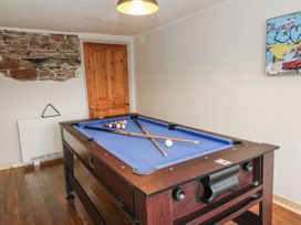 A game room with a pool table and wall artwork at Daisy Cottage in Wigton