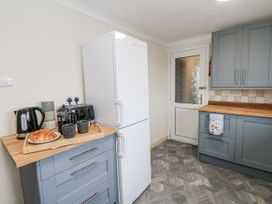 A kitchen with appliances and food items at Daisy Cottage in Wigton