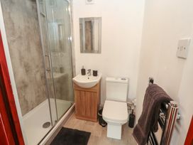A bathroom with a shower, toilet, and sink at Daisy Cottage Near Wigton
