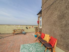 An outdoor space with a table and chairs at Daisy Cottage near Wigton