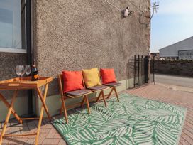 An outdoor seating area with chairs and a table at Daisy Cottage Near Wigton